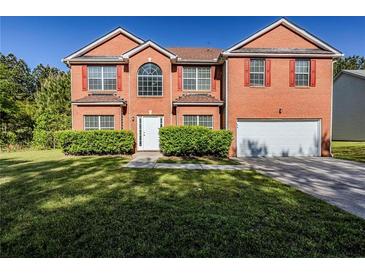 Traditional two-story brick home featuring a manicured lawn, red shutters and a two-car garage at 5011 Wewatta Sw St, Atlanta, GA 30331