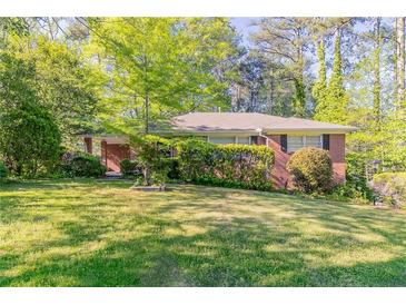 Charming brick home with a well-maintained front lawn and mature trees offers great curb appeal at 2345 Leith Ave, Atlanta, GA 30344