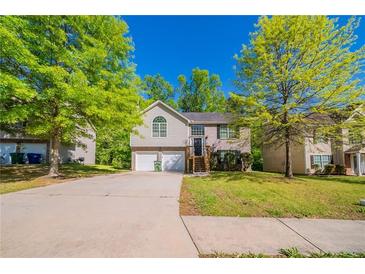Charming home featuring a well-maintained lawn, two-car garage, and inviting entryway at 3568 Oakshire Se Way, Atlanta, GA 30354