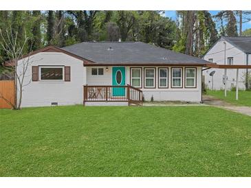 Charming home featuring a teal front door, inviting porch, and a well-manicured lawn at 2681 Tilson Rd, Decatur, GA 30032