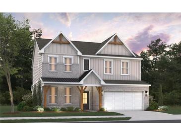 Charming two-story home boasts a modern exterior, complemented by lush landscaping, and a two-car garage at 4082 Adler Cir, Buford, GA 30519