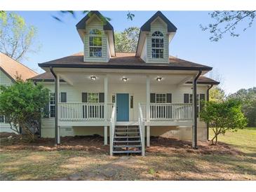 Charming home with a covered front porch, white siding, and a well-manicured lawn at 280 Old Carrollton Rd, Carrollton, GA 30116