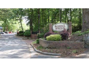 Roswell Springs sign near the community entrance and tree-lined street at 310 Warm Springs Cir, Roswell, GA 30075