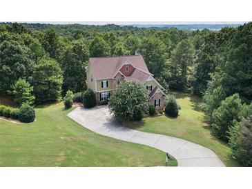 Beautiful two-story home with a stone facade and a large, curved driveway at 5737 Russell Ct, Douglasville, GA 30135