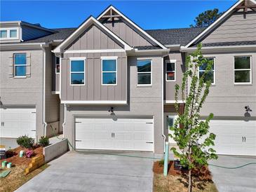 Charming townhome features painted brick, white garage door, and well-maintained landscaping at 1217 Fern Ridge Ct # 16, Norcross, GA 30093