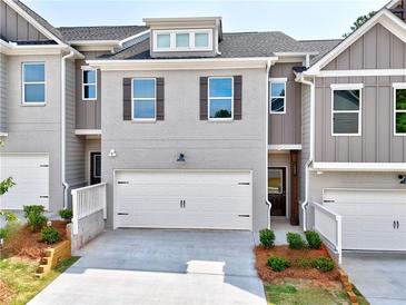 New construction townhome with a two-car garage and beautifully landscaped front yard at 1227 Fern Ridge Ct # 17, Norcross, GA 30093