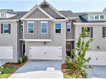Beautiful two-story home featuring a two-car garage, brickwork and grey siding at 1237 Fern Ridge Ct # 18, Norcross, GA 30093