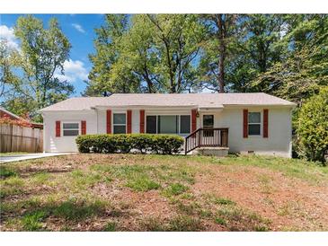 Charming single-story home featuring a cozy porch and red shutters at 1907 Clarke Ln, Decatur, GA 30035