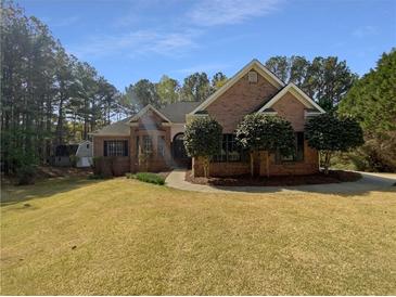 Charming brick home featuring manicured landscaping and a well-maintained lawn at 105 Laurel Ridge Ct, Fayetteville, GA 30215
