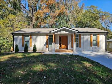 Charming one-story home with a well-manicured lawn and attractive wooden door and window shutters at 185 Glenrose Sw Cir, Atlanta, GA 30354