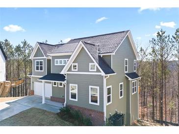 Two-story home featuring neutral siding, a dark roof, white trim, and an attached two-car garage at 3180 Tackett Rd, Douglasville, GA 30135