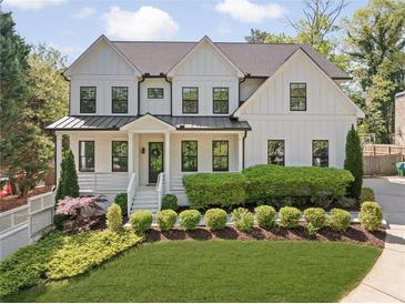 Charming two-story home with white siding, black-framed windows, manicured landscaping, and a well-maintained front yard at 1395 Oconee Ne Pass, Brookhaven, GA 30319