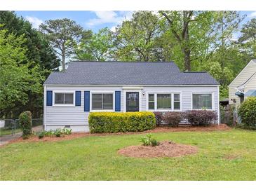Charming home featuring a well-manicured lawn and tasteful landscaping with blue shutters on a sunny day at 561 Allendale Dr, Decatur, GA 30032