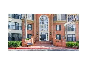 Brick exterior with large arched entry and stairs leads to the front doors of the homes at 23101 Plantation Ne Dr, Atlanta, GA 30324