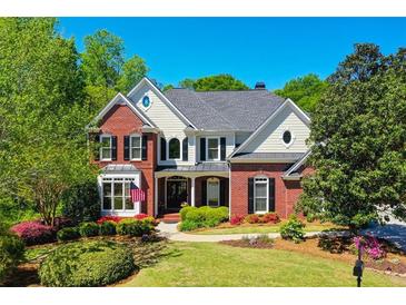 Charming two-story home with a manicured lawn and mature landscaping, perfect for families at 844 Nob Ridge Dr, Marietta, GA 30064