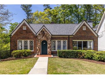 Charming brick home with stone accents and a well-manicured lawn at 1900 Ridgewood Ne Dr, Atlanta, GA 30307