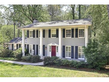 Charming two-story home with a classic brick facade, black shutters, and a well-manicured front lawn at 2789 Townley Cir, Atlanta, GA 30340