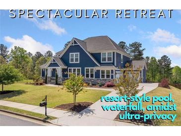 Stately two-story home with manicured lawn, mature trees, charming front porch, and inviting curb appeal at 2111 Harmony Dr, Canton, GA 30115