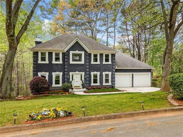 Charming two-story home features manicured front lawn and two-car garage at 3522 Evans Ridge Trl, Atlanta, GA 30340