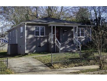 Charming single-story home with gray painted brick, a welcoming front porch, and landscaped yard at 60 Cleveland Se St, Atlanta, GA 30316