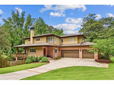 Stunning home featuring an attached two car garage, brick exterior and well manicured lawn at 1155 Mcconnell Dr, Decatur, GA 30033