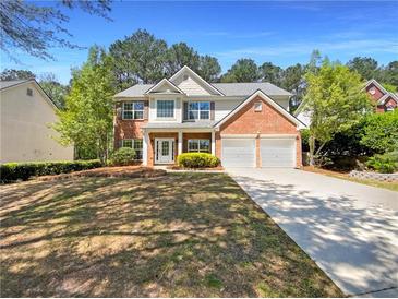 Charming two-story home with brick accents, a well-maintained lawn, and a two-car garage in a desirable neighborhood at 956 Buckhorn Bnd, Locust Grove, GA 30248