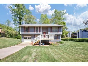 Charming two-story home with a well-manicured lawn and inviting front deck at 3560 Riverchase Dr, Decatur, GA 30034