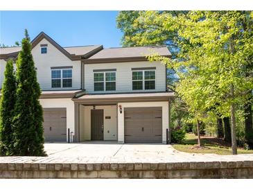 Charming townhome featuring two-car garage and well-maintained front yard at 2857 Regal Park # 3, Atlanta, GA 30318