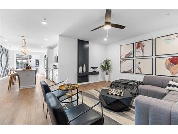 A spacious living room featuring modern furniture, striking wall art and beautiful hardwood flooring at 371 Grant Se Cir # 1822, Atlanta, GA 30315