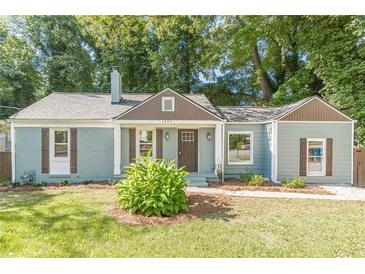 Charming craftsman-style home with a manicured lawn, quaint shutters, and inviting front entrance at 1404 E Forrest Ave, Atlanta, GA 30344