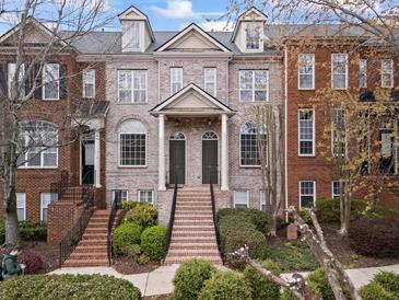 Charming brick townhomes with inviting entryways and manicured landscaping offer classic curb appeal at 1123 Providence Pl, Decatur, GA 30033