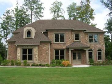 Charming brick home featuring a well-manicured lawn and traditional architectural details at 2365 Barrington Trace Sw Cir, Atlanta, GA 30331