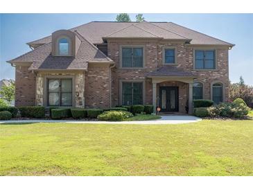 Charming brick two-story home with manicured lawn and landscaping provides beautiful curb appeal at 2365 Barrington Trace Sw Cir, Atlanta, GA 30331