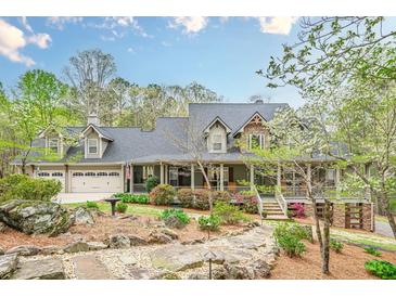 Charming home featuring a landscaped front yard, covered porch, dormer windows, and a three-car garage at 18 Crolley Ln, White, GA 30184