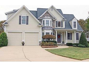 Charming two-story home with a two-car garage, stone accents, manicured lawn and inviting front porch at 278 Vine Creek Dr, Acworth, GA 30101
