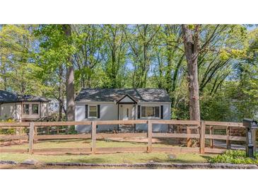 Charming single-story home with a fenced yard and mature trees offering both curb appeal and privacy at 2162 Doris Dr, Decatur, GA 30034