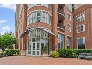 Elegant brick building entrance featuring modern architectural details and manicured landscaping at 325 E Paces Ferry Ne Rd # 312, Atlanta, GA 30305