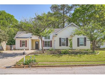 Charming one story home with manicured lawn and a combination of windows and shutters at 772 Bostonian Way, Lawrenceville, GA 30046