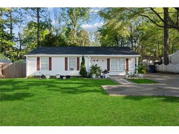 Charming single-story home with lush green lawn, red shutters, and fresh exterior paint at 5573 Singleton Rd, Norcross, GA 30093