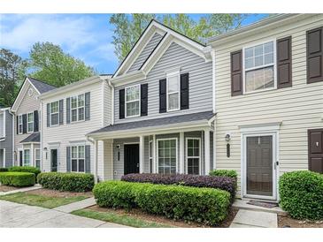 Charming townhome featuring a welcoming entrance, well-maintained landscaping, and classic architectural details at 1728 Devon Sw Dr, Atlanta, GA 30311