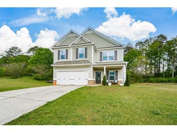 Charming two-story home with a well-manicured lawn and attached two-car garage at 74 Macland Mill Ln, Dallas, GA 30157