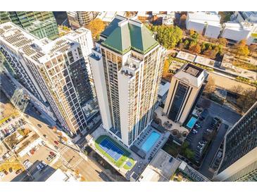A stunning aerial view of a modern high-rise apartment building, showcasing its pool, tennis court, and prime location at 1280 W Peachtree Nw St # 2201, Atlanta, GA 30309