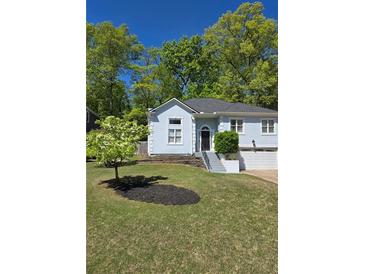 Charming home with a well-manicured lawn, attached garage and inviting entryway at 760 Whitehall Way, Roswell, GA 30076