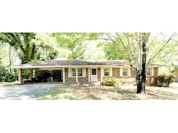 Charming single-story brick home with a welcoming carport and a well-maintained front yard at 811 Verde Dr, Riverdale, GA 30274