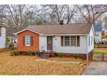 Charming single-story home with brick and siding, featuring a well-maintained front yard and inviting entrance at 933 Dell Se Ave, Smyrna, GA 30080