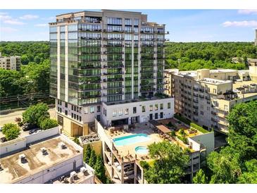 Stunning exterior view of a modern high-rise condominium with a rooftop pool and surrounding green space at 2233 Peachtree Ne Rd # 1207, Atlanta, GA 30309