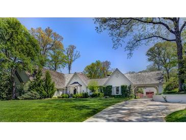 Beautiful home exterior featuring a well-manicured lawn, long driveway, and lush landscaping at 3489 Knollwood Nw Dr, Atlanta, GA 30305