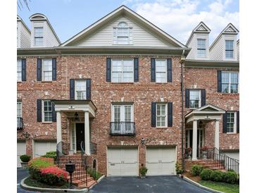 Charming brick townhome featuring black shutters, dormer windows, and well-maintained landscaping at 3707 Peachtree Ne Rd # 8, Atlanta, GA 30319