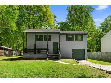 Charming two-story home featuring a covered front porch and well-maintained lawn and driveway at 6703 Cameron Rd, Morrow, GA 30260