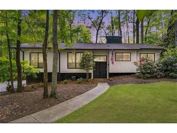 Charming one-story home with a landscaped front yard and mature trees at 230 Summerfield Dr, Alpharetta, GA 30022